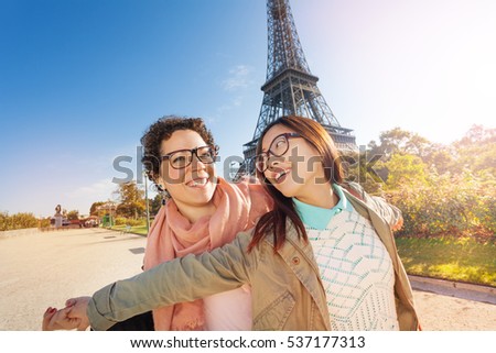Happy travelers having fun on the streets of Paris