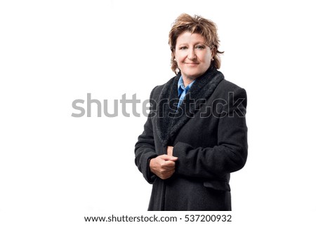 
An adult woman wears a black hair coat isolated on white background