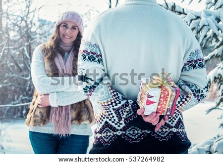 Man is going to give his girlfriend a gift in winter forest