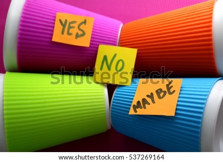 yes no maybe yellow post it sticky reminder notes on the colorful background; choice, alternatives, options