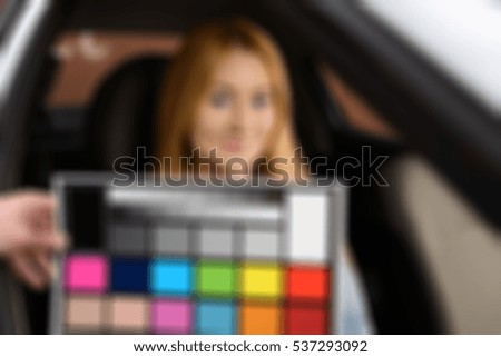 Blond woman driving car theme creative abstract blur background with bokeh effect