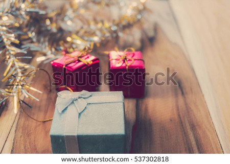 Christmas and New Year gift box Background on a wooden. Retro vintage filter effect.