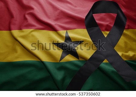 waving national flag of ghana with black mourning ribbon