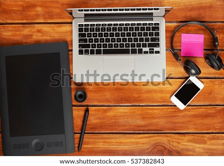 Photographer workspace on wooden desk table. Photography gadgets view from above