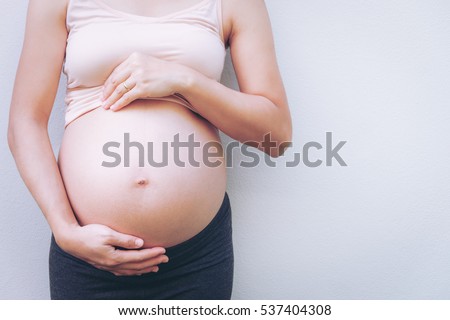 Close up of pregnant belly. Royalty-Free Stock Photo #537404308