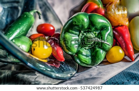 Several peppers and tomatoes laying on the table. Photograph still life art photo background backdrop 