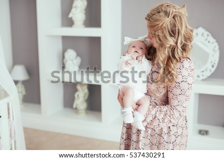 Happy loving family. Mother and child girl playing, kissing and hugging