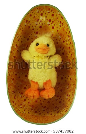 yellow toy Easter chick in the egg on white