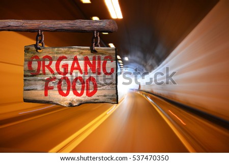 Organic food motivational phrase sign on old wood with blurred background