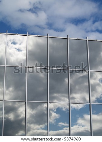 Clouds above mirror windows reflection of clouds