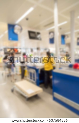 blur picture background  of customer queue for pay money at shopping counter  cashier  with customer assistant in furniture mall 
