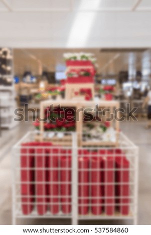 blur picture background of Christmas tree or Plastic Poinsettia plastic flowers display showroom in furniture mall
