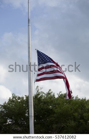 American flag at half mast for mourning and holidays