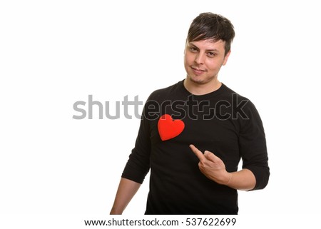 Studio shot of Caucasian man pointing finger to heart ready for Valentine's day