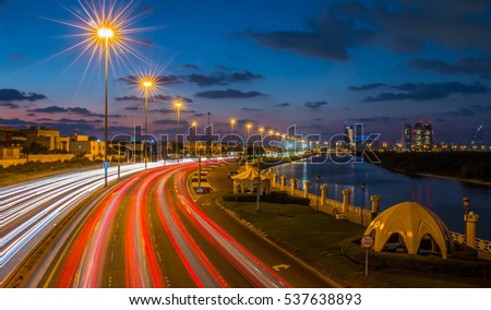 A night shot from Salam street,Abu Dhabi. The iconic Al Bahar Tower is in background and water canal in the right and road in the left.