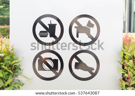Sign do not bring food, do not wear shoes, do dogs, no photography allowed,