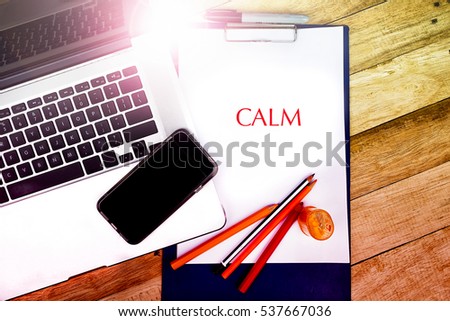  CALM word, text write at notepad in wooden background. typography concepts.

