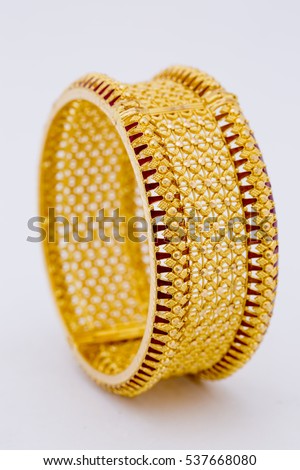 Beautiful gold bangle isolated on white background. Gold jewellery stock photo. Royalty-Free Stock Photo #537668080