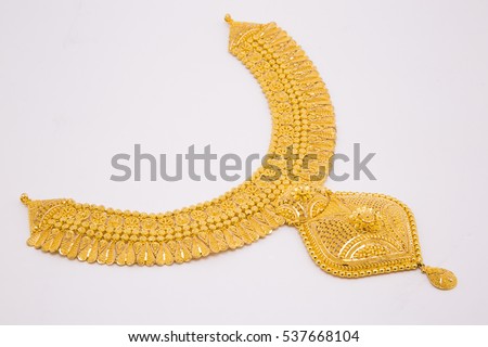 Beautiful gold neckless isolated on black background. Gold jewellery stock photo. Royalty-Free Stock Photo #537668104