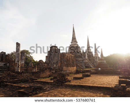 backlit picture of big old brick pagoda with sunset of background at watphrasisanpetch ayutthaya