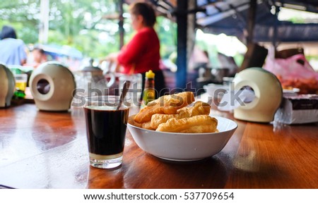 Patongko,Twin bread and coffee,  laos style breakfast  at local restaurant in luangprabang, Laos. Royalty-Free Stock Photo #537709654