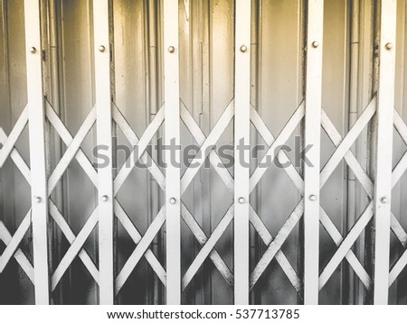 Black and white retro expaned metal folding door detail, asian style /yellow, grey, dark grey lighting shadow