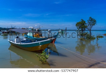 Fishing boats in the harbour at Port Dickson Beach, Negeri Sembilan, Malaysia. The image may have soft, blurry and noise due to long exposure
