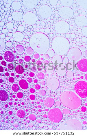 Oil drops floating in water abstract multi color background