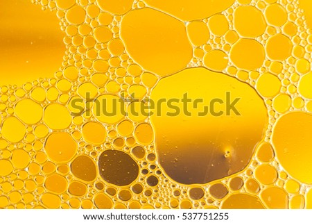 Oil drops floating in water abstract orange color background