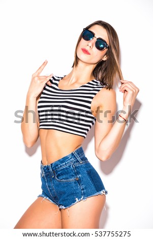 attractive beautiful woman having fun on the white wall,wearing vintage sunglasses,outfit and hat, vacation style