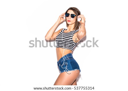 attractive beautiful woman having fun on the white wall,wearing vintage sunglasses,outfit and hat, vacation style