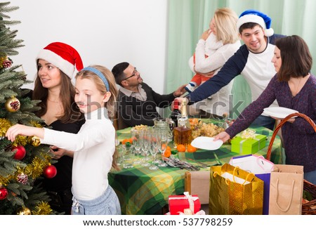 Happy big family celebrating Christmas together at home. Focus on girl
