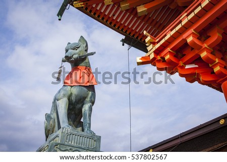 Statue of the fox-like deity Inari in Fushimi Inari Shrine, Kyoto, Japan