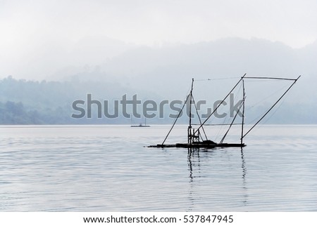 Picture of lake in Thailand early morning with the presence of old-style fishing station.