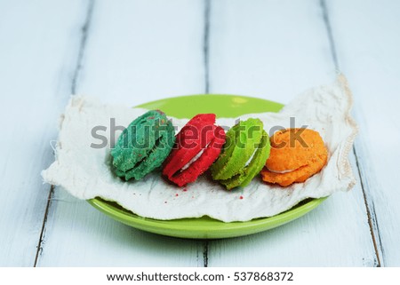 Close up of Homemade colorful cookies on napkin and wood table concept, selective focus, vintage style.