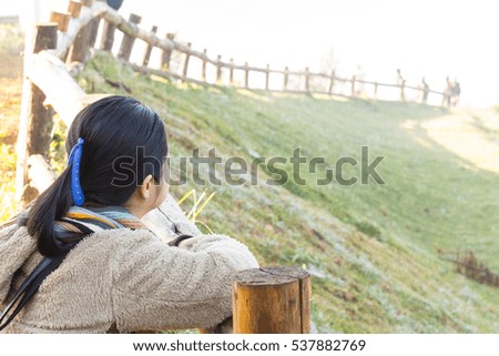 Woman sits on the mountain indicate if beautiful view,Thailand.