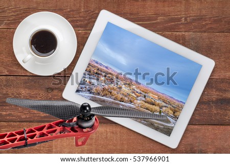 aerial view of Fort Collins downtown, Poudre River and a bike trail on digital tablet with coffee and drone propeller, screen image 