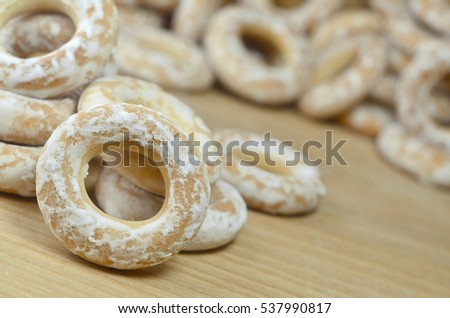 Still life of donut glaze on a wooden surface. Glazed bagels are a small bunch on a wooden table. Flour sweets to the Tea Party