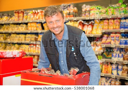 Sales assistant doing a stock take at supermarket
