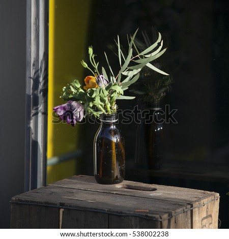 flowers in the old pharmacy bottles adorn storefronts