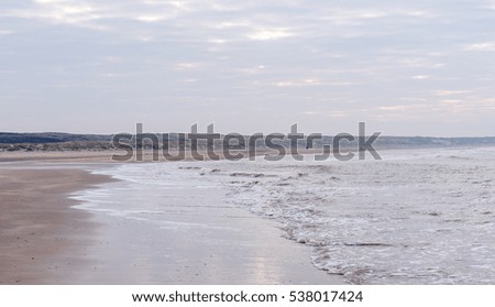Landscape picture from the dutch sea at the beach in the Netherlands. Cloudy sky at the background. 