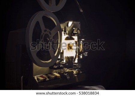Vintage 8mm film projector on a dark background