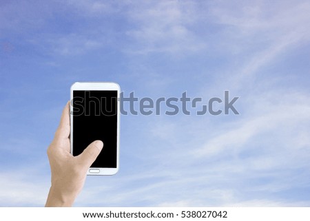 Man use mobile phone, blue sky as background.