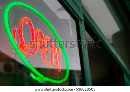 Neon sign of a store with the word Open