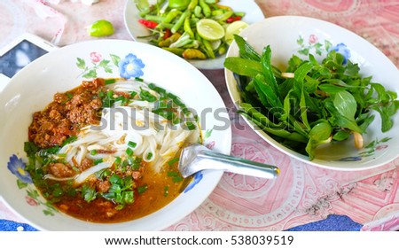 laos food ,Pho, Laos Style Beef Noodle Soup with vegetables on table. Royalty-Free Stock Photo #538039519