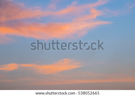 orange clouds in the blue sky background