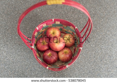 Red basket of red apples on kitchen counter