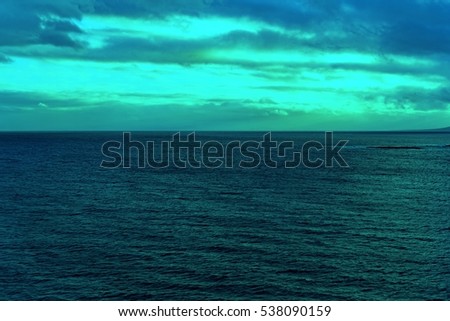 Atlantic Ocean with dramatic colorful sky and clouds. Cruising along Islands, view from cruise ship, image with color filter effect for tourism business concept, travel blogs, creative photo website