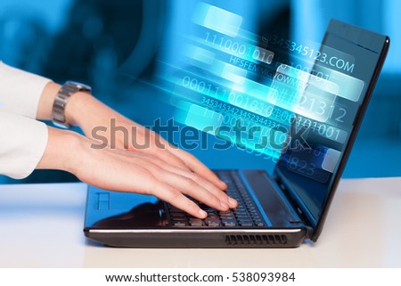 Close up of man typing on laptop computer with glowing technology effect Royalty-Free Stock Photo #538093984