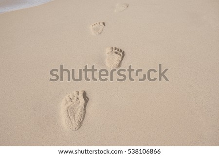 foots with sand on the beach.